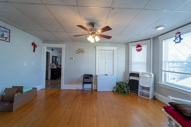 misc room featuring ceiling fan, hardwood / wood-style floors, and a healthy amount of sunlight