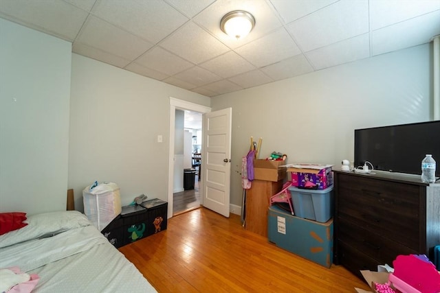 bedroom featuring a paneled ceiling and hardwood / wood-style flooring