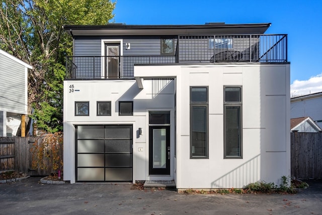 view of front facade featuring a balcony and a garage