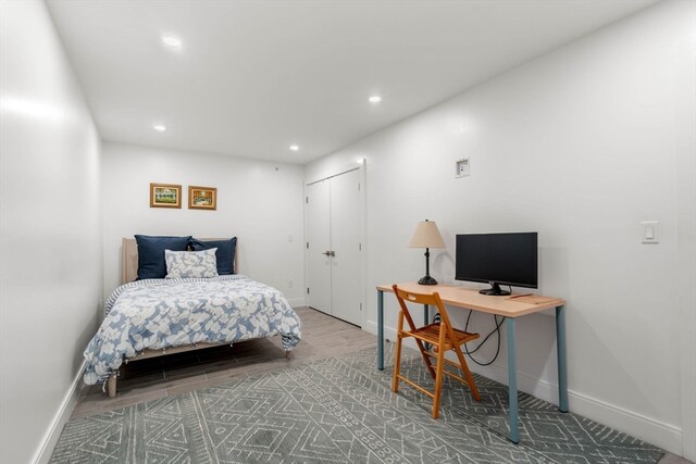 bedroom featuring hardwood / wood-style floors and a closet