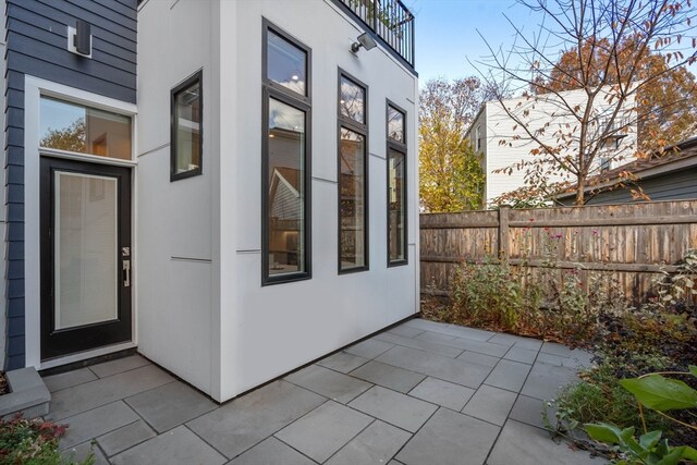 view of side of home with a patio