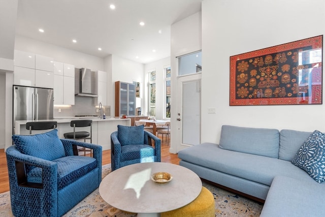 living room featuring light hardwood / wood-style flooring and sink