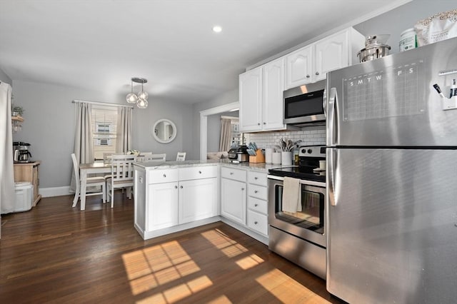 20-A Franklin St, Peabody, MA 01960 - kitchen featuring appliances with stainless steel finishes, a peninsula, white cabinetry, plenty of natural light, and recessed lighting