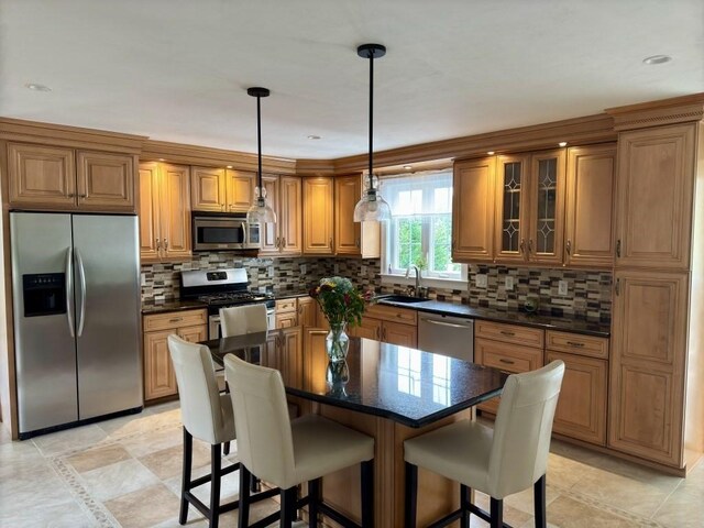 6 Cedar Creek Dr, Attleboro, MA 02703 - kitchen featuring a sink, appliances with stainless steel finishes, brown cabinets, and a kitchen bar
