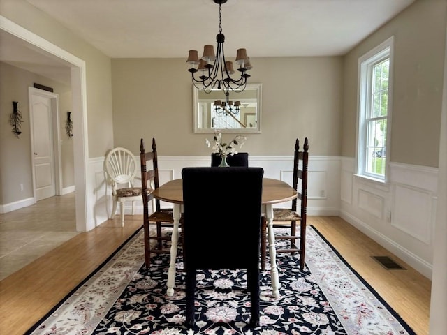 6 Cedar Creek Dr, Attleboro, MA 02703 - dining room with a notable chandelier, a wainscoted wall, visible vents, and light wood-type flooring