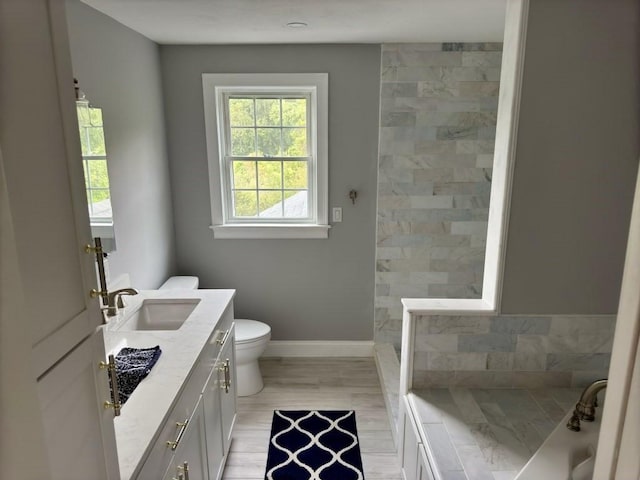 6 Cedar Creek Dr, Attleboro, MA 02703 - bathroom featuring vanity, toilet, a washtub, baseboards, and a tile shower