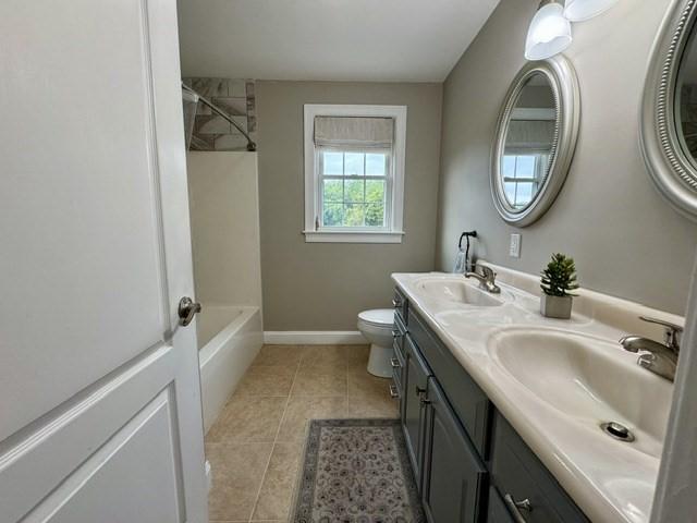 6 Cedar Creek Dr, Attleboro, MA 02703 - bathroom with tile patterned flooring, a sink, double vanity, and toilet
