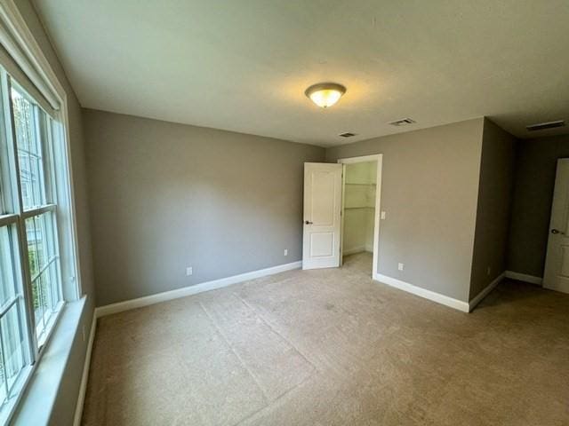 6 Cedar Creek Dr, Attleboro, MA 02703 - unfurnished bedroom featuring baseboards, multiple windows, light carpet, and a spacious closet