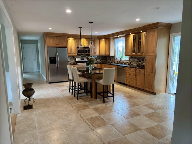 6 Cedar Creek Dr, Attleboro, MA 02703 - kitchen featuring decorative backsplash, visible vents, dark countertops, brown cabinets, and stainless steel appliances