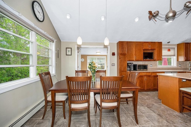 dining space featuring a baseboard radiator, vaulted ceiling, light stone finish flooring, and recessed lighting