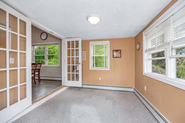 carpeted empty room with baseboard heating and french doors
