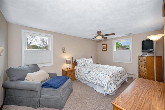 bedroom featuring multiple windows, carpet flooring, a baseboard radiator, and ceiling fan