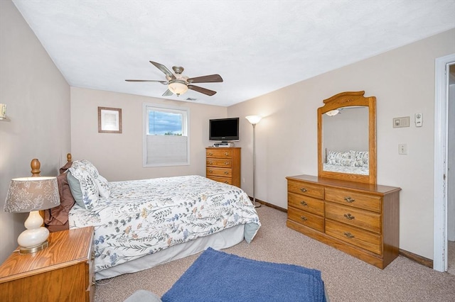 carpeted bedroom featuring baseboards and a ceiling fan