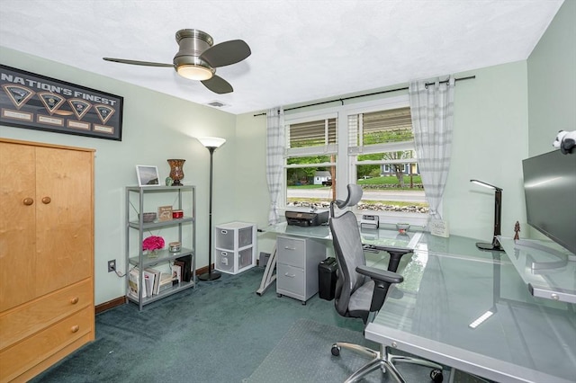 carpeted home office with ceiling fan and baseboards