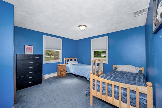bedroom featuring carpet floors, baseboards, and a textured ceiling