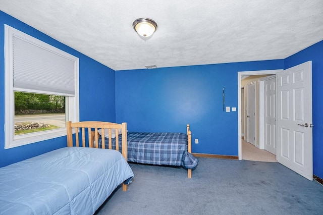 bedroom featuring carpet flooring and baseboards