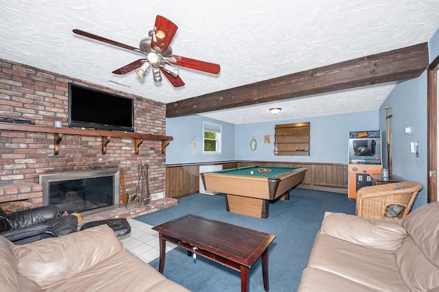 rec room with a textured ceiling, a wainscoted wall, a ceiling fan, beamed ceiling, and billiards table