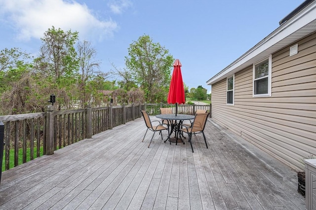 wooden deck featuring outdoor dining area