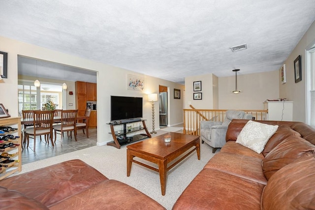 living room featuring baseboards and light carpet