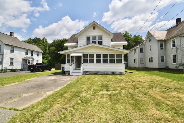 176 N Blvd, West Springfield, MA 01089 - view of front of property featuring a sunroom, roof with shingles, entry steps, and a front yard