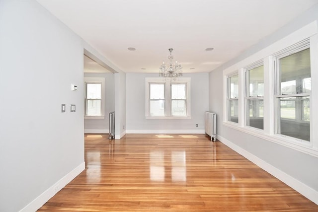176 N Blvd, West Springfield, MA 01089 - unfurnished dining area featuring radiator, a chandelier, plenty of natural light, and light wood-style floors