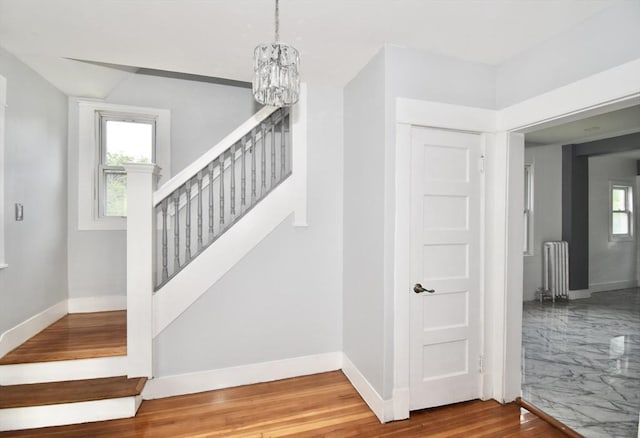 176 N Blvd, West Springfield, MA 01089 - staircase with radiator, wood finished floors, and a chandelier