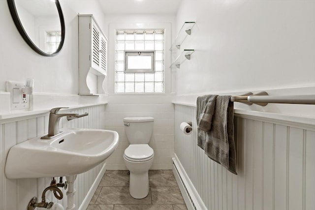 half bath featuring toilet, wainscoting, and a baseboard radiator