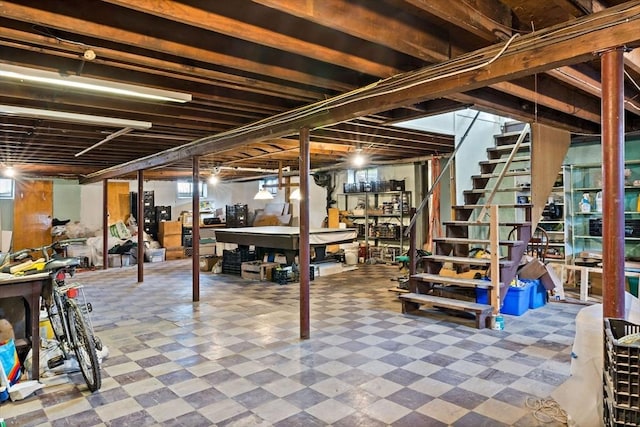 basement with tile patterned floors and stairway