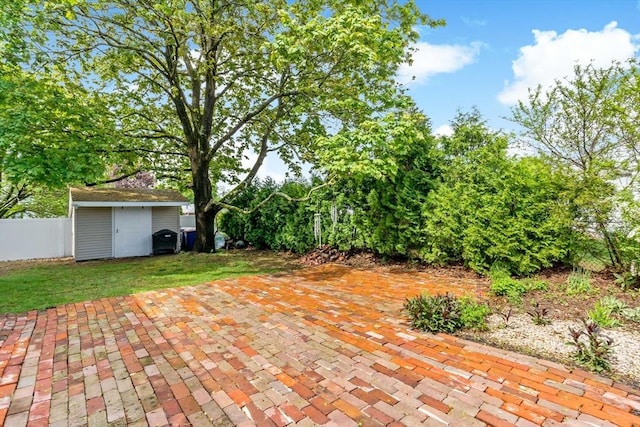 view of patio / terrace with an outbuilding and a shed