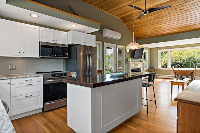 kitchen featuring stainless steel appliances, wood ceiling, a wall mounted air conditioner, vaulted ceiling, and ceiling fan