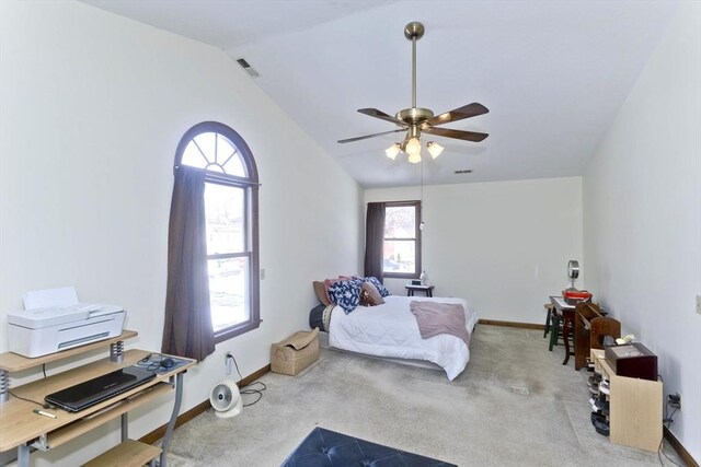 carpeted bedroom featuring lofted ceiling, a ceiling fan, visible vents, and baseboards