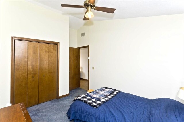 bedroom with visible vents, ceiling fan, vaulted ceiling, carpet floors, and a closet