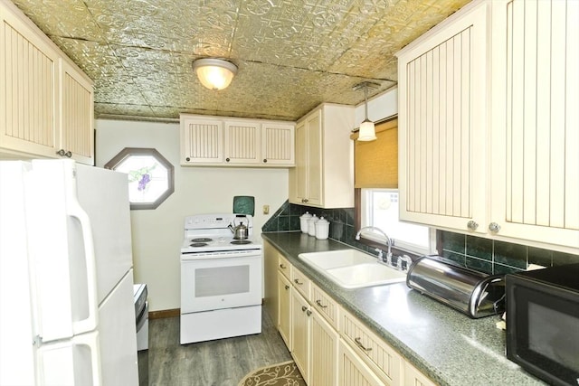 kitchen with white appliances, an ornate ceiling, dark wood-style flooring, a sink, and backsplash