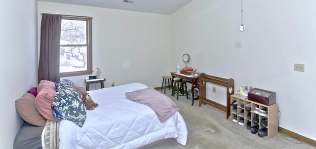 carpeted bedroom featuring visible vents and baseboards