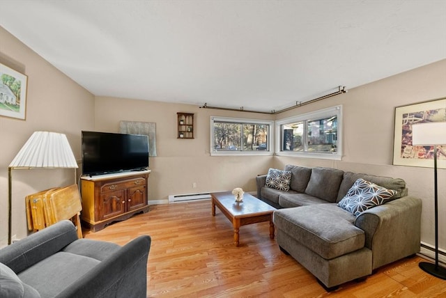 living area with light wood-type flooring, baseboards, and a baseboard radiator