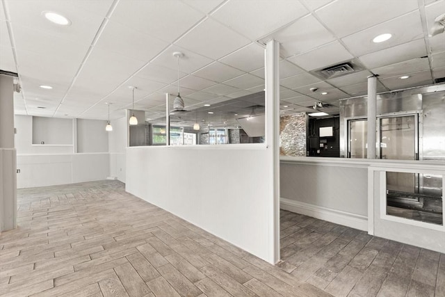 surrounding community with a drop ceiling and recessed lighting