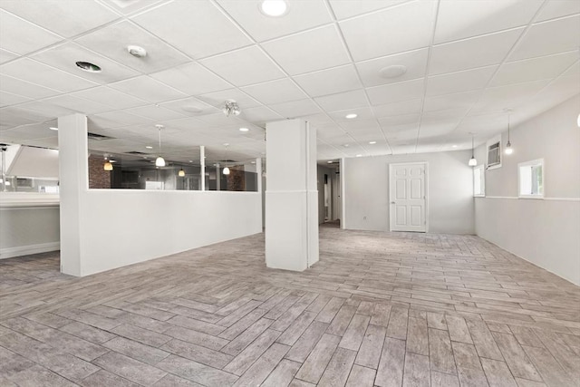 basement with wood finished floors, a paneled ceiling, and recessed lighting