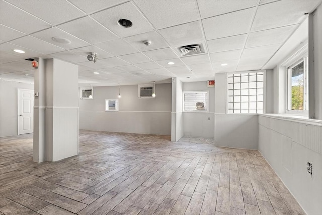 spare room featuring plenty of natural light, parquet floors, a drop ceiling, and recessed lighting
