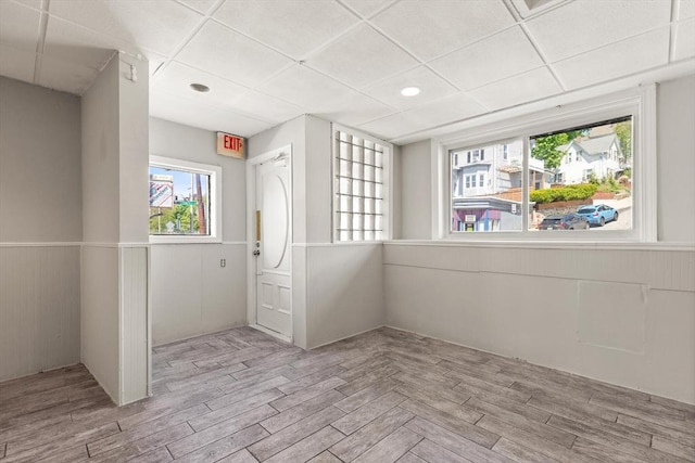 empty room featuring plenty of natural light, wood finished floors, and recessed lighting
