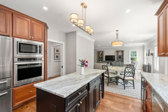 16 Winfield St, Needham, MA 02492 - kitchen with appliances with stainless steel finishes, open floor plan, crown molding, light wood-style floors, and decorative light fixtures