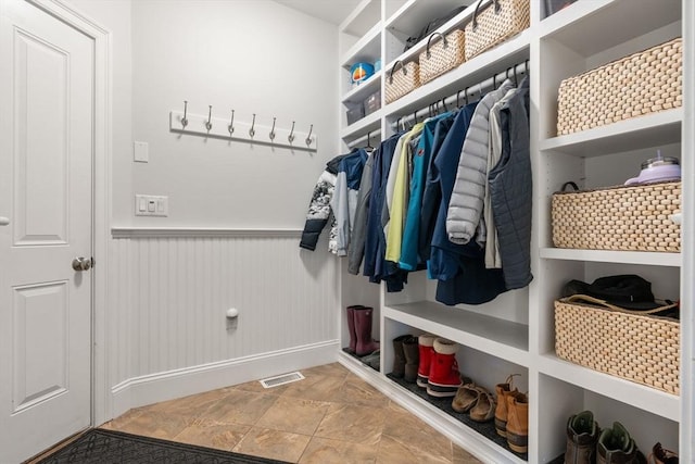 16 Winfield St, Needham, MA 02492 - mudroom featuring wainscoting and stone finish floors