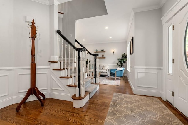16 Winfield St, Needham, MA 02492 - foyer entrance with stairway, wood finished floors, crown molding, a wainscoted wall, and a decorative wall