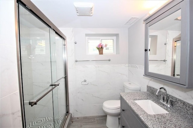 318 Concord Ave Unit 1, Cambridge, MA 02138 - full bath featuring tile walls, a marble finish shower, toilet, and vanity