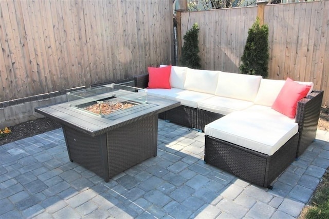 318 Concord Ave Unit 1, Cambridge, MA 02138 - fenced backyard with an outdoor living space with a fire pit and a patio area