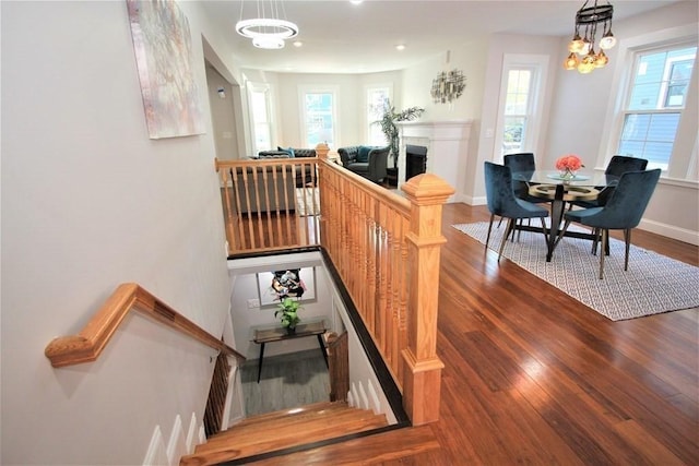 318 Concord Ave Unit 1, Cambridge, MA 02138 - staircase featuring wood finished floors, healthy amount of natural light, baseboards, and a fireplace