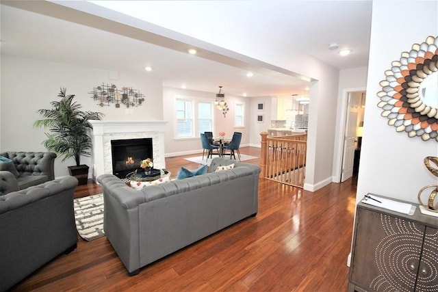 318 Concord Ave Unit 1, Cambridge, MA 02138 - living room with dark wood-style flooring, a glass covered fireplace, recessed lighting, baseboards, and a chandelier