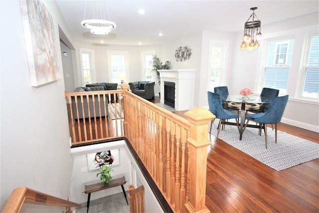 318 Concord Ave Unit 1, Cambridge, MA 02138 - stairs with a chandelier, healthy amount of natural light, wood finished floors, a glass covered fireplace, and recessed lighting