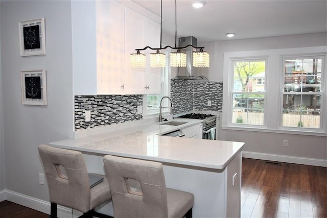 318 Concord Ave Unit 1, Cambridge, MA 02138 - kitchen featuring high end stainless steel range, light countertops, baseboards, white cabinetry, and dark wood-style floors