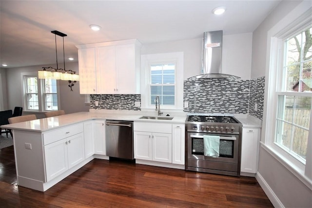318 Concord Ave Unit 1, Cambridge, MA 02138 - kitchen with stainless steel appliances, a sink, wall chimney range hood, light countertops, and recessed lighting