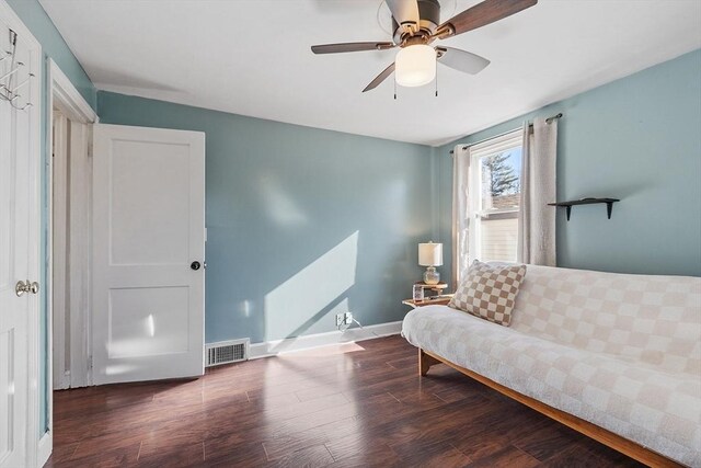 sitting room with visible vents, baseboards, wood finished floors, and a ceiling fan